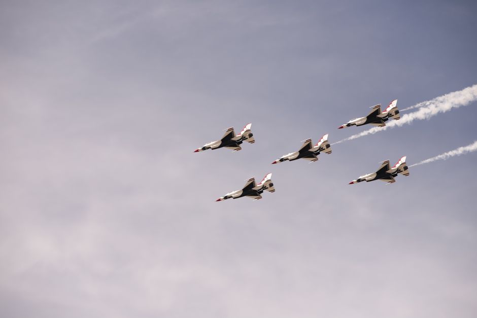 Impressive aerobatic display of jets in formation against a clear sky.