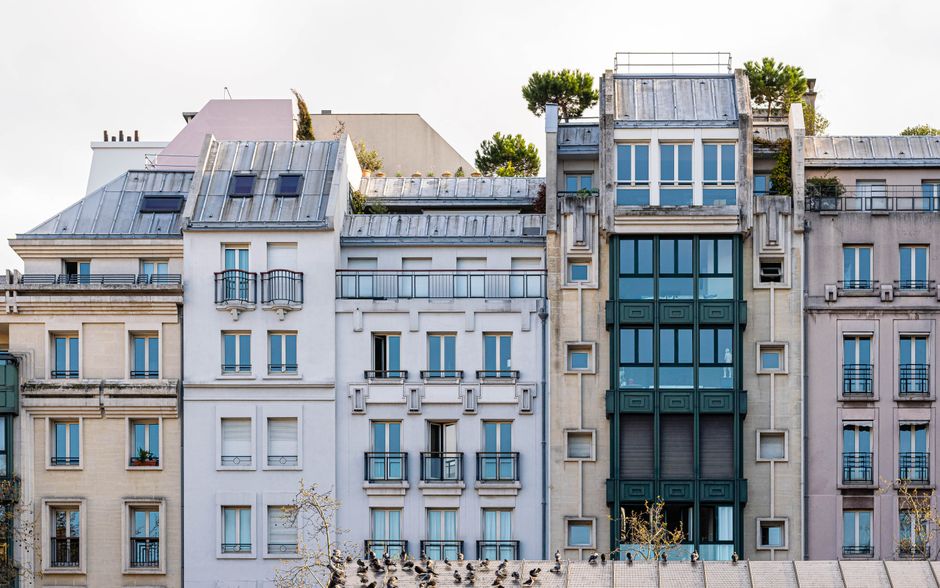 A picturesque view of a classic Parisian building facade with balconies and windows.